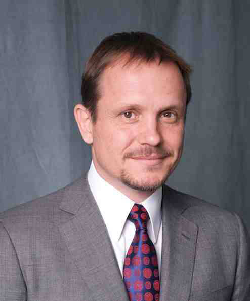 A person wearing a suit and tieDescription automatically generated